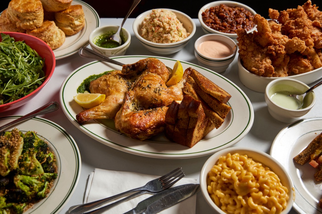 A catering table piled with fried chicken, biscuits, sides and pie